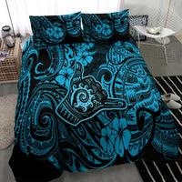 Blue Polynesian patterned bedding set with turquoise tiki-style motifs, three-quarter view