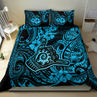 Blue Polynesian patterned bedding set with matching pillowcases, straight-on bed view