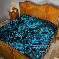 Blue Polynesian shaka pattern quilt with black backing on bed