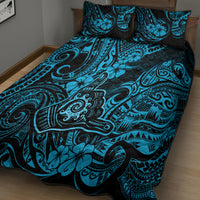 Blue and black patterned quilt with two pillow shams on a bed