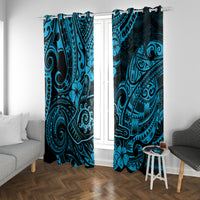 Blue Polynesian patterned curtains hanging on a window with tribal face motifs