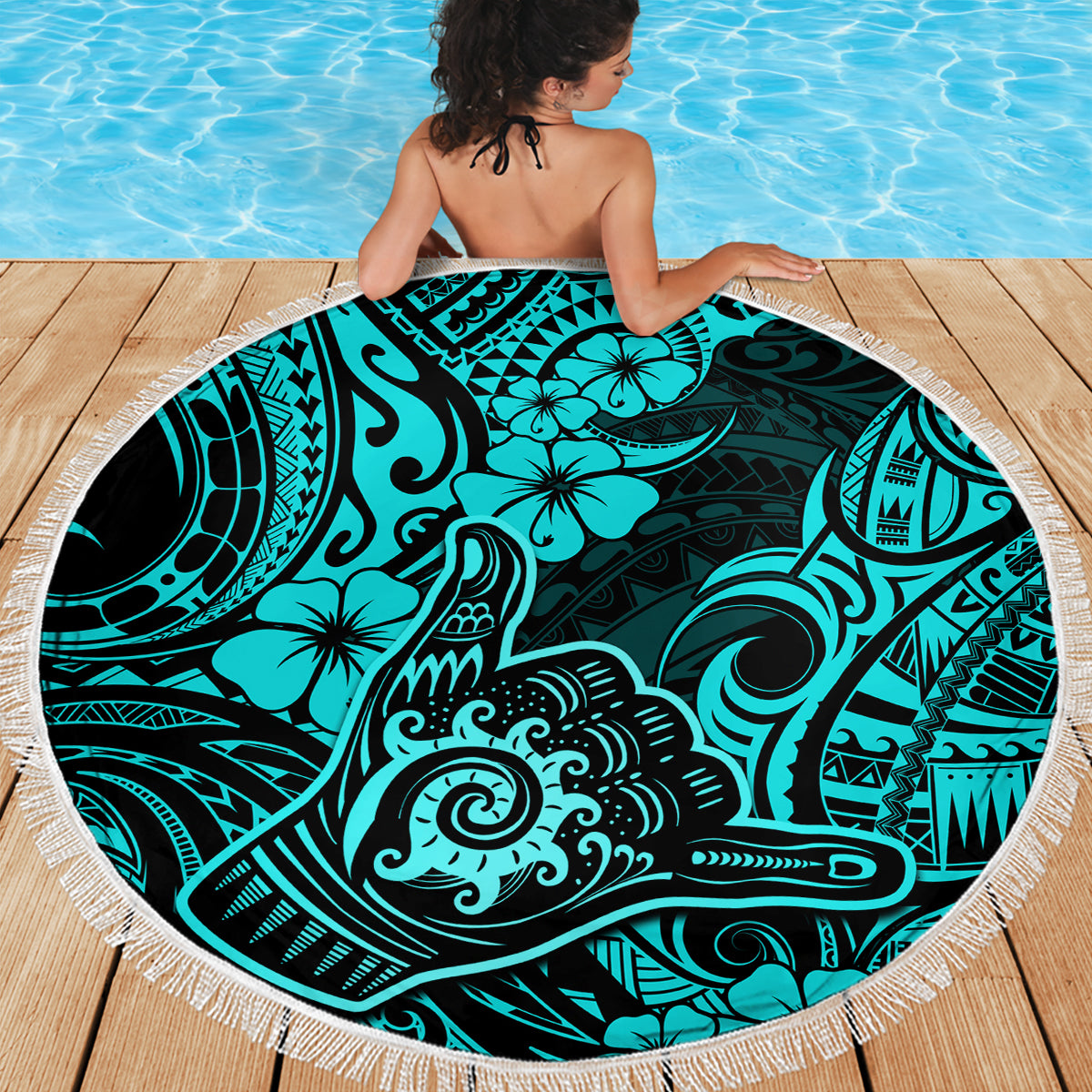 Turquoise round beach blanket with fringe border and Polynesian print