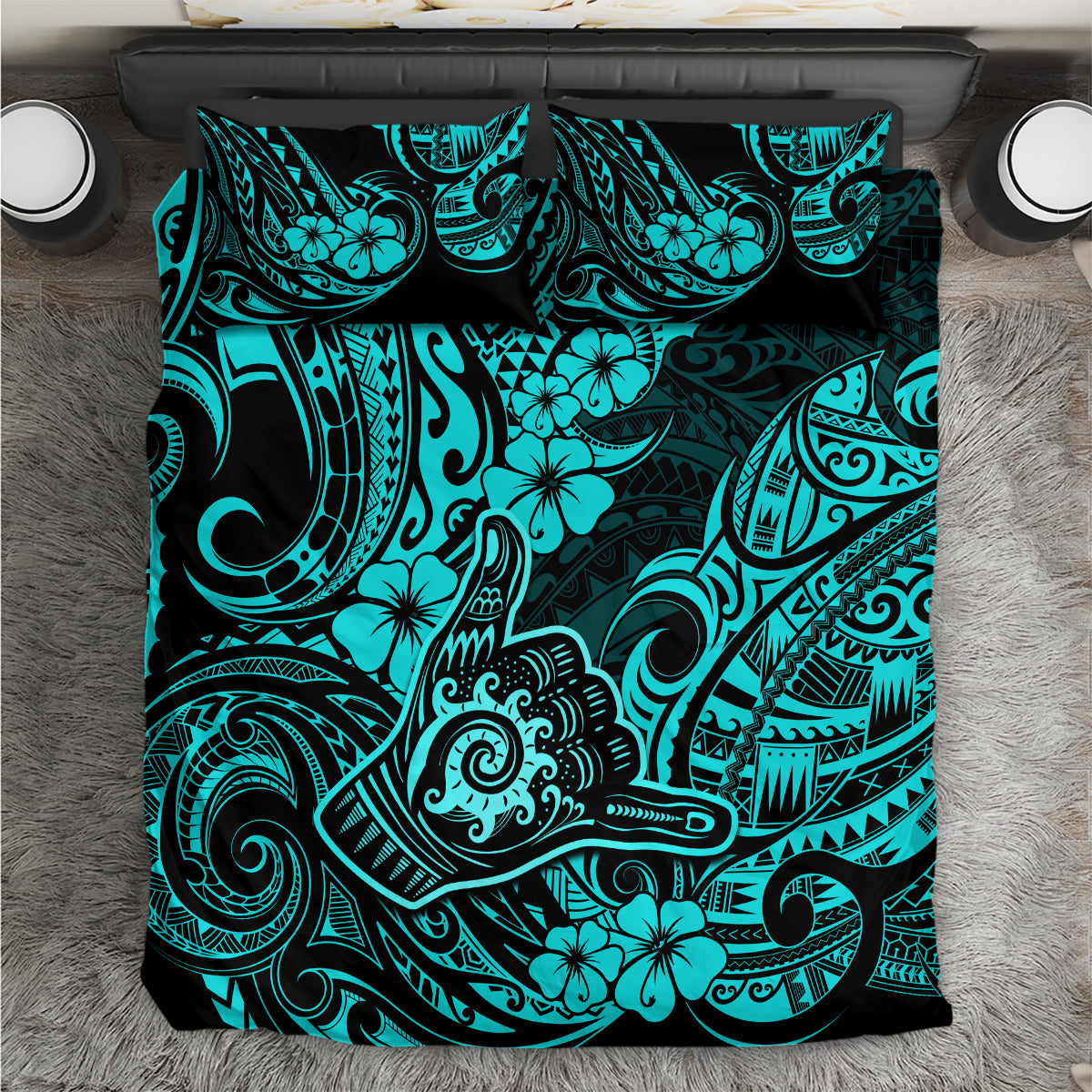 Turquoise and black Polynesian print duvet cover set, folded on bed