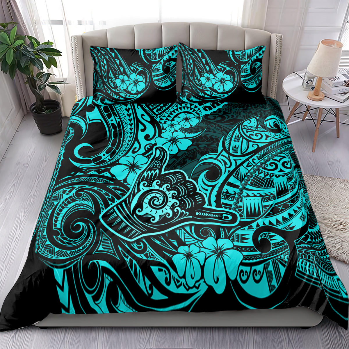 Turquoise and black Polynesian print bedding set with pillow shams on bed