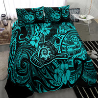 Turquoise and black Polynesian print duvet cover with pillow shams on bed