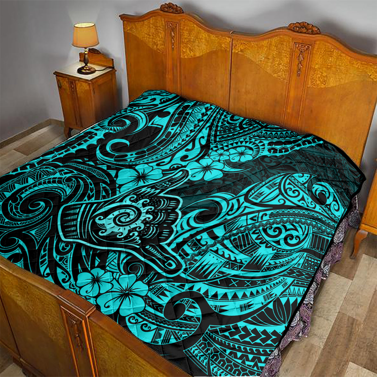 Turquoise Polynesian pattern quilt on bed with black-and-blue decorative motifs