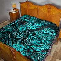 Turquoise Polynesian pattern quilt on bed with black-and-blue decorative motifs