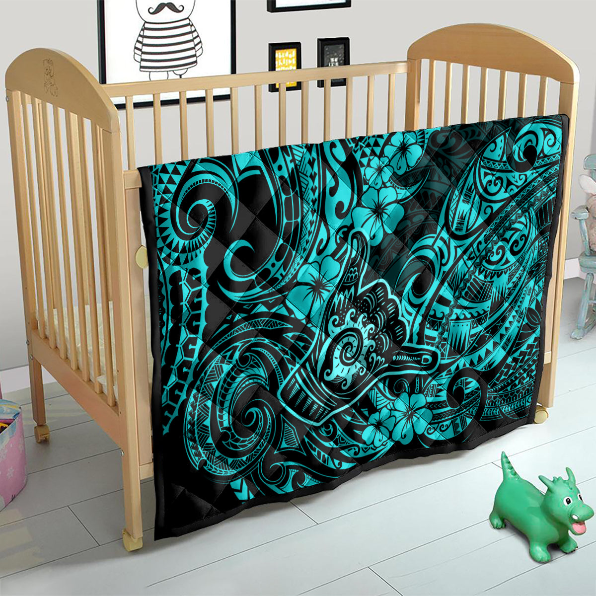 Turquoise Polynesian pattern quilt on a wooden crib mattress