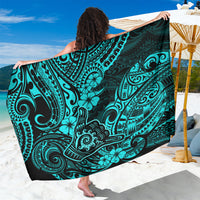 Turquoise Polynesian patterned sarong with black border, folded and draped