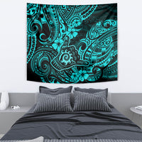 Turquoise and dark tribal design tapestry hung on a wall