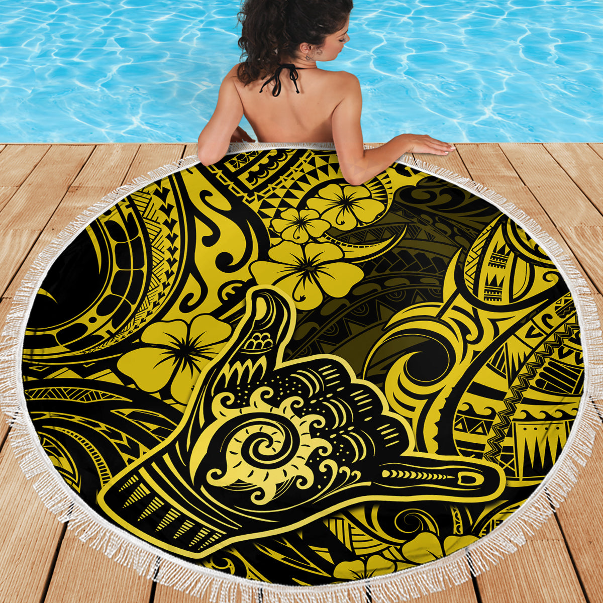 Round beach blanket with white fringe, bright yellow hibiscus and tribal motifs on dark base