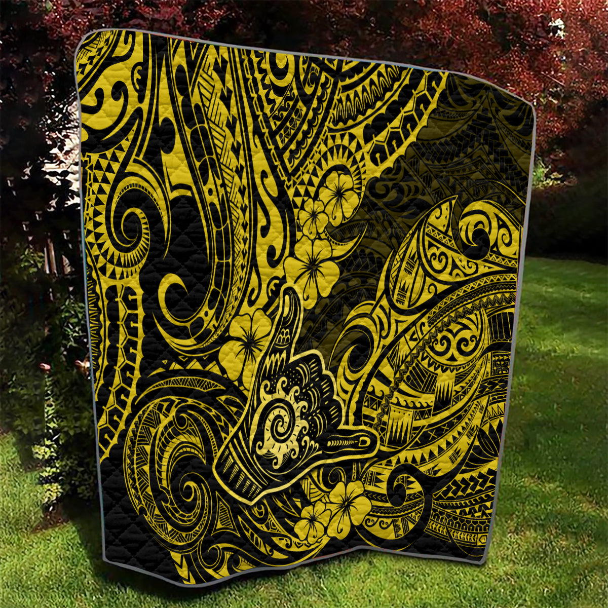 Polynesian shaka sign quilt with yellow tribal swirls, detailed borders, and flowers
