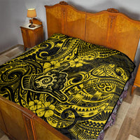 Polynesian shaka sign quilt on bedspread, yellow and black with floral scroll motifs