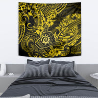 Polynesian-style yellow and black tapestry featuring ornate swirls and hibiscus flowers