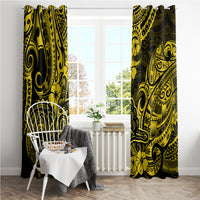 Yellow and black patterned window curtain panels in front of a sunny window