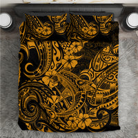Gold and black Polynesian patterned bedding set on flat surface
