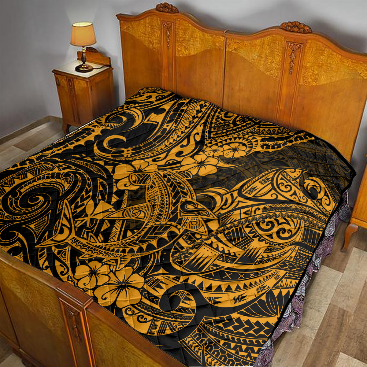 Gold and black Polynesian shark quilt on bed, ornate tribal scroll and flower design