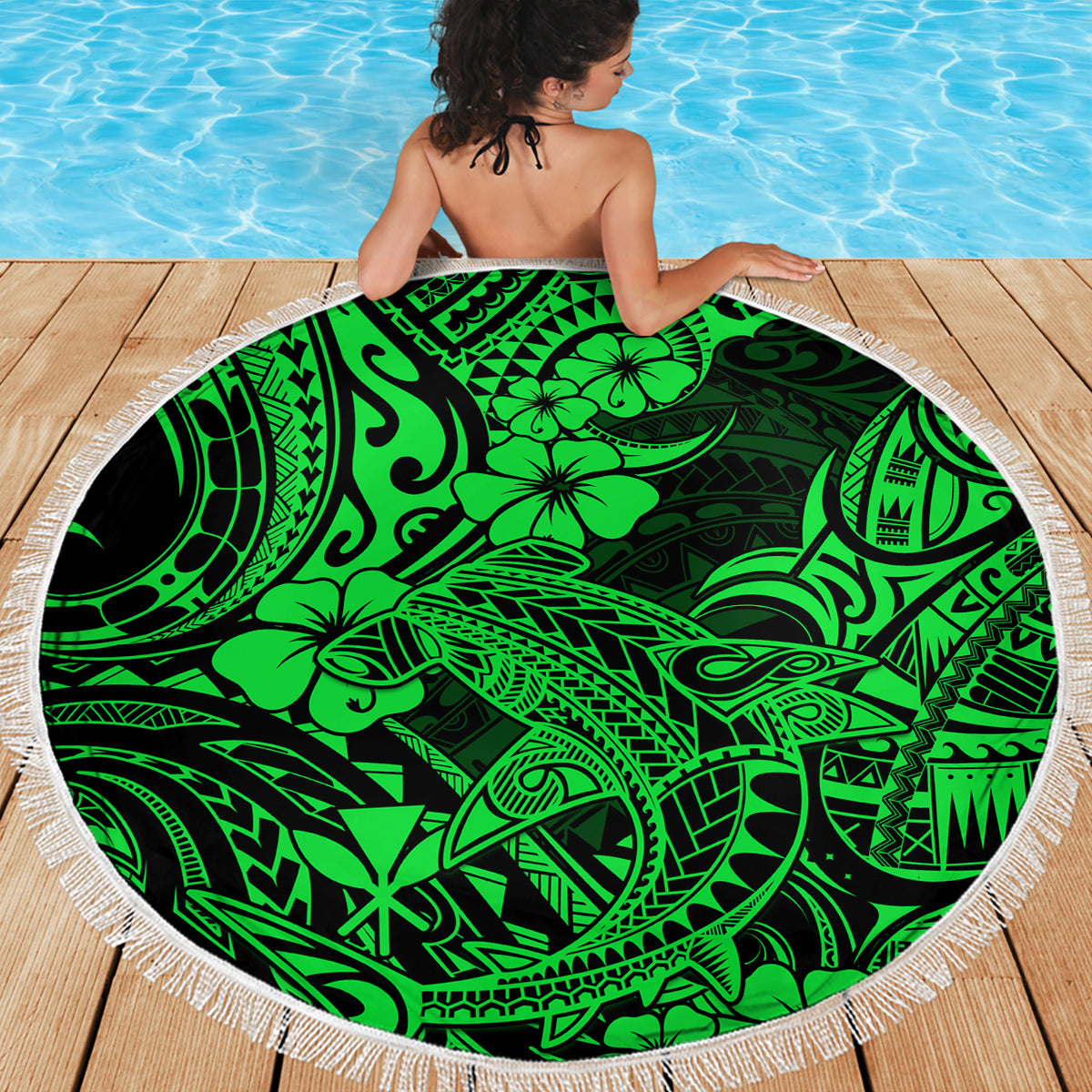 Green round beach blanket with white fringe, tribal shark and hibiscus pattern