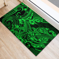 Green rubber doormat with Polynesian shark tribal motifs and black border, lying flat