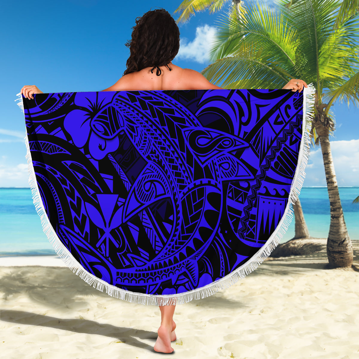 Round navy beach blanket with fringed edge and Polynesian shark pattern, draped