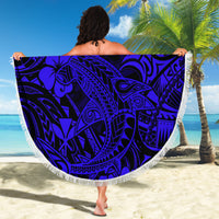 Round navy beach blanket with fringed edge and Polynesian shark pattern, draped