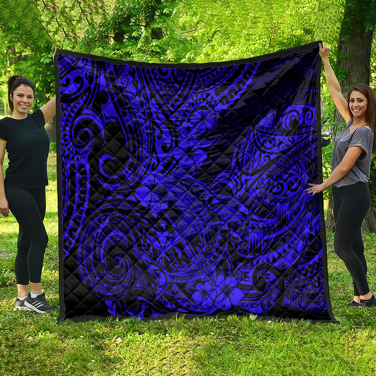 Navy-blue patterned Hawaii shark quilt with black swirling designs and flower accents, large throw