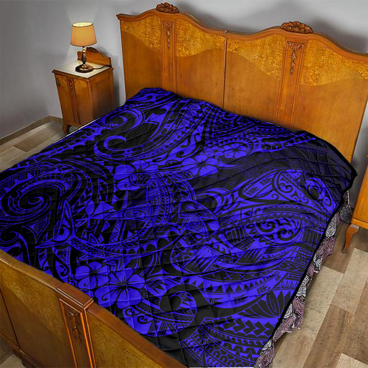 Navy-blue Hawaii shark quilt spread on bed, black background with swirl and flower pattern