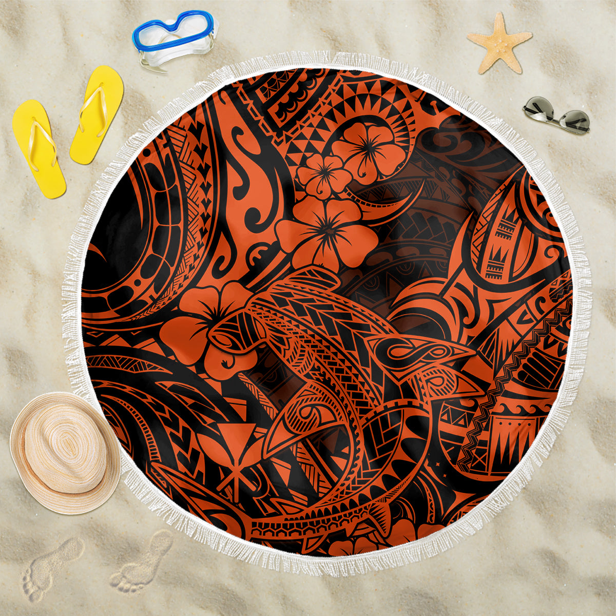 Round beach blanket with orange and black Polynesian tiki pattern, white fringe edge