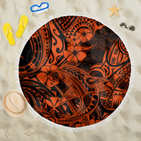 Round beach blanket with orange and black Polynesian tiki pattern, white fringe edge