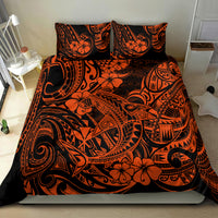 Orange and black Polynesian pattern bedding set on bed with two pillow shams