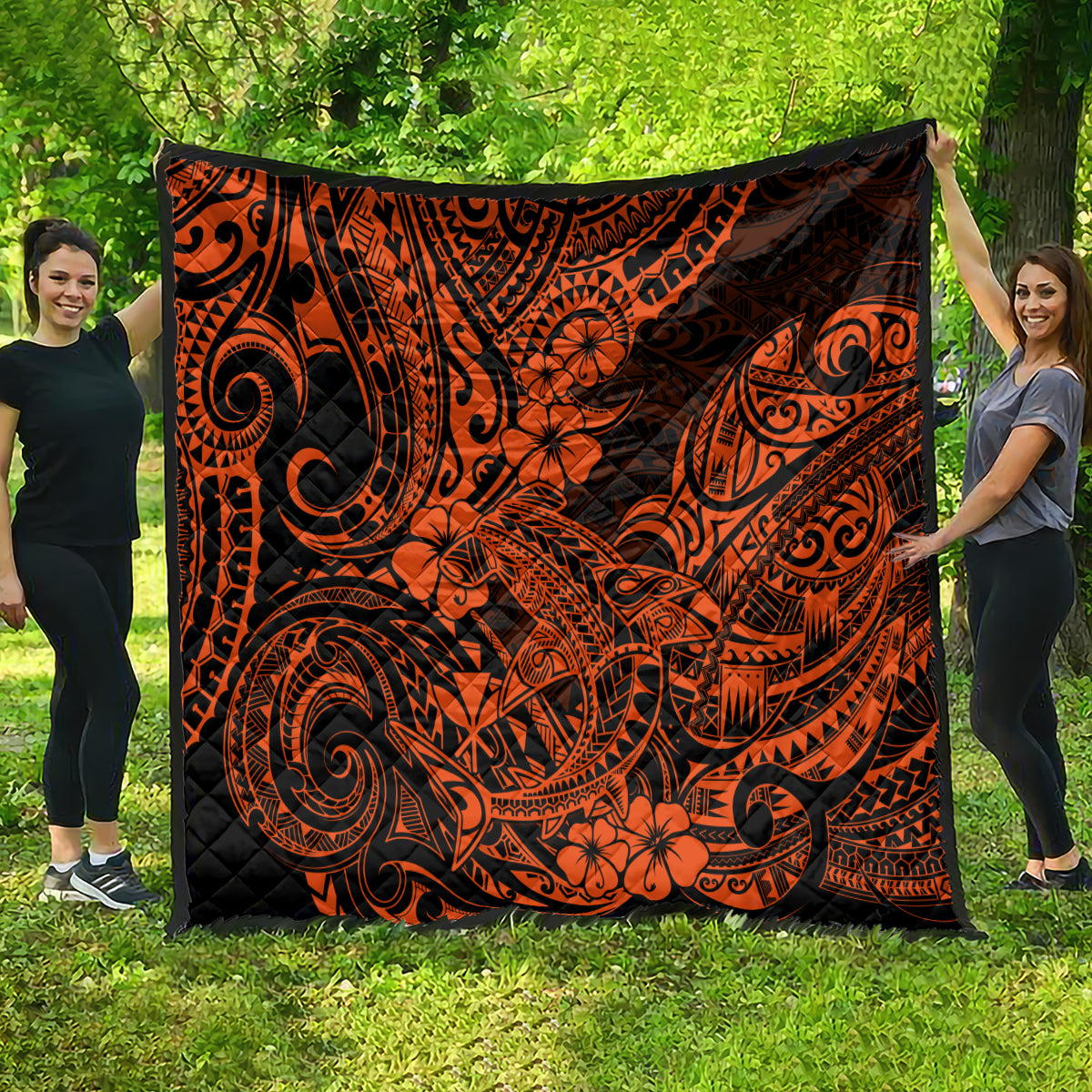 Orange and black Polynesian-style quilt, large tribal swirls with flower accents