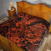 Orange and black Polynesian-style quilt laid on a bed, tribal swirls with flowers