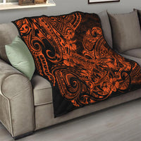 Orange and black Polynesian-style quilt over a sofa, bold tribal swirls and floral motifs