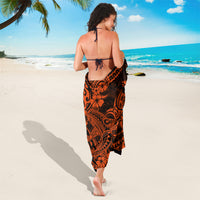 Orange and black patterned sarong tied at waist, back view