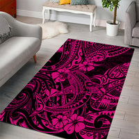 Rectangular pink area rug with dark swirls and hibiscus flower motifs