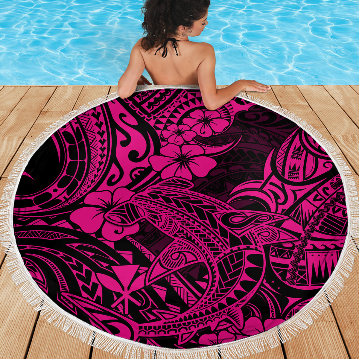 Round beach blanket with pink Polynesian-style shark motif and fringed rim