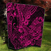 Pink and black Polynesian shark pattern quilt blanket, draped on grass