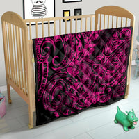 Pink and black Polynesian shark pattern quilt blanket on a crib