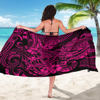 Pink-and-black Polynesian shark sarong with swirling tribal print, tied at waist (back view).