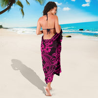 Pink-and-black Polynesian sarong wrap with flowing tribal motifs, tied at waist.