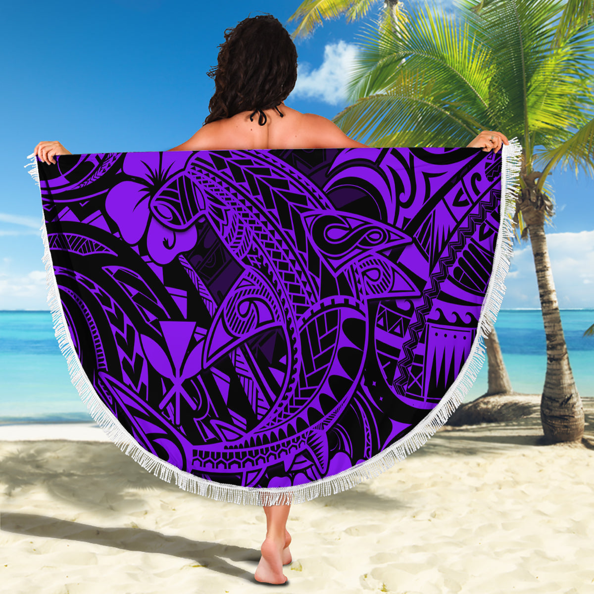 Purple round beach blanket with Polynesian shark pattern, held up with fringe border