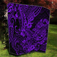 Purple Polynesian-style quilt shown full on a lawn, black pattern with flower and swirl details