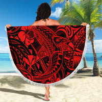 Red round beach blanket with black Polynesian-style tribal pattern and white fringe edge