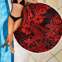 Red round beach blanket with black tribal hibiscus pattern and white fringe border by pool
