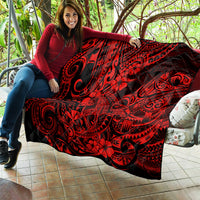 Red and black Polynesian shark pattern quilt, laid over outdoor seating with swirls.