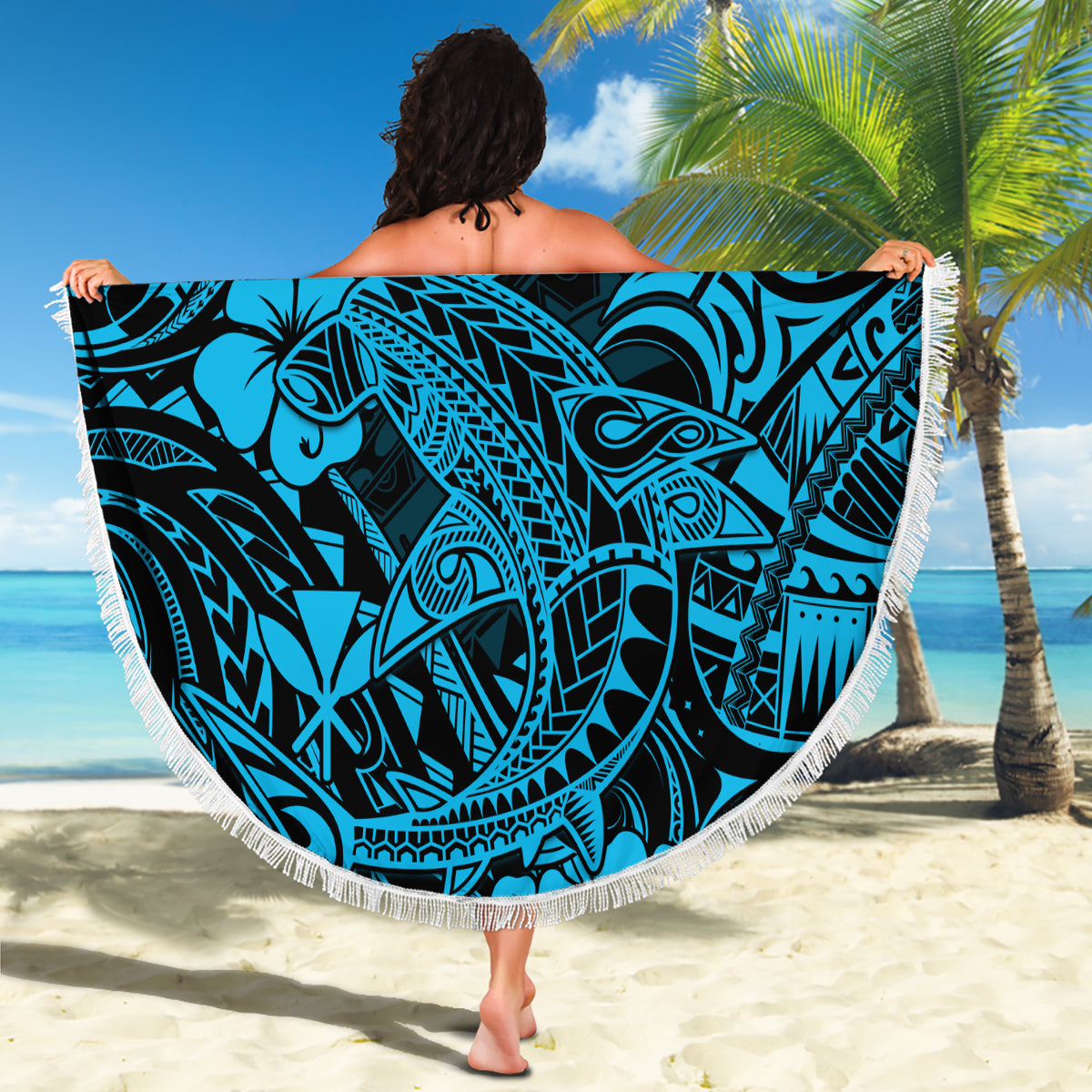 Round beach blanket held up, sky blue Polynesian shark design with fringe
