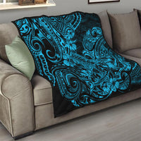 Polynesian shark quilt on sofa, black-and-turquoise tribal swirl design with hibiscus flowers