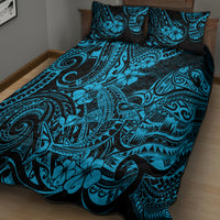 Blue and black Polynesian pattern quilt bed set with two pillow shams on bed
