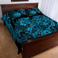 Blue and black Polynesian pattern quilt with pillow shams on wooden bed frame
