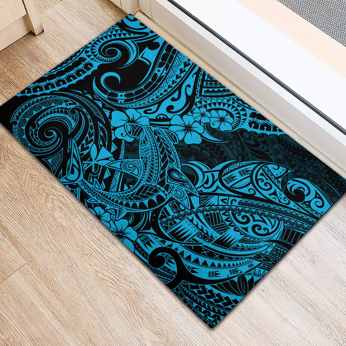 Rectangular blue Polynesian-pattern rubber doormat with dark border and floral swirls